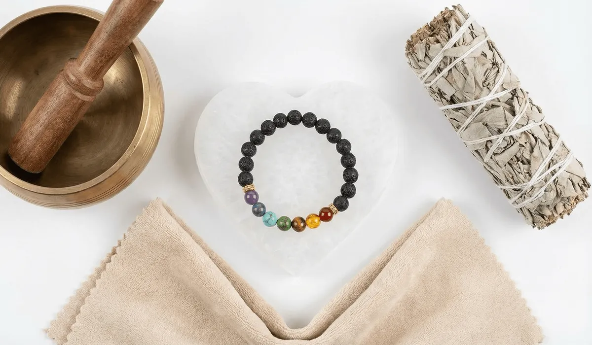 The Meaning of Buddha Bracelets: A Guide to Symbolism, Benefits, and Proper Wear 4 - Buddha Bodhis A collection of spiritual cleansing tools including a Selenite plate, sage smudge stick, and Tibetan singing bowl used for charging Buddha bracelets.