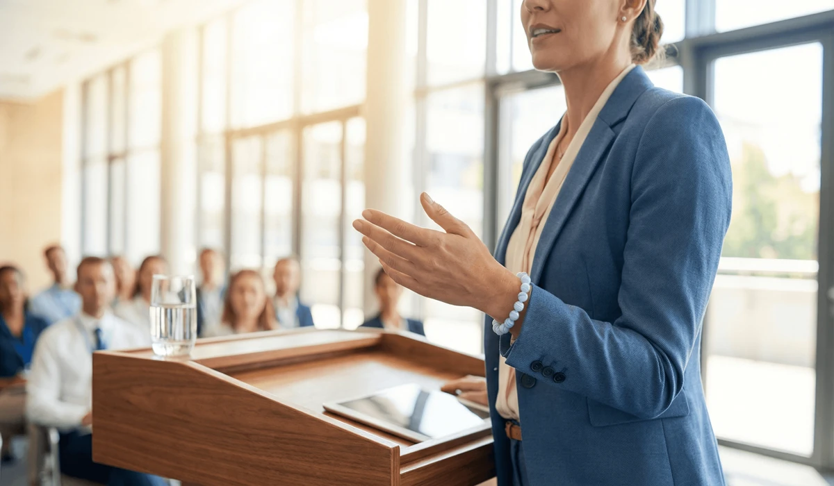 Blue Lace Agate: Healing Properties for Anxiety and Peaceful Communication 2 - Buddha Bodhis A public speaker wearing a Blue Lace Agate bracelet to promote calm and effective verbal expression during a presentation.