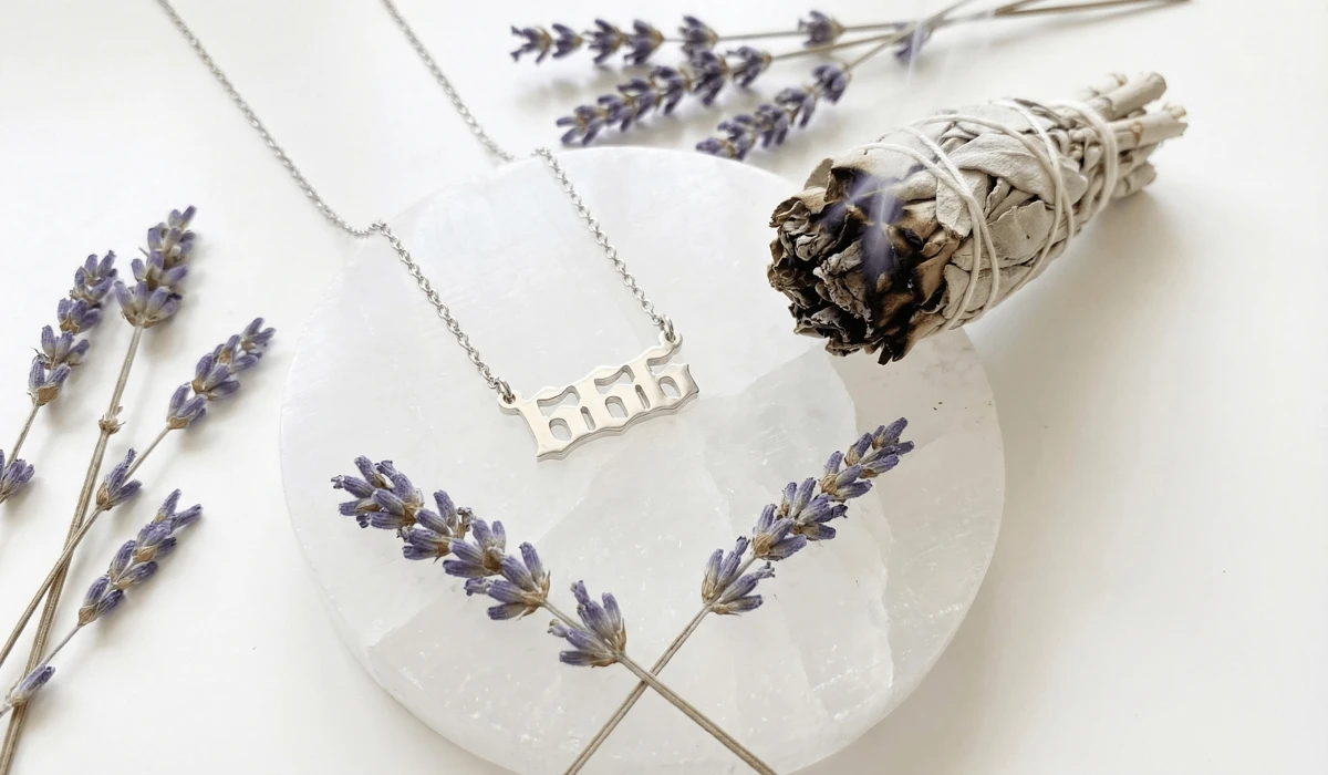 The Meaning of a 666 Angel Number Necklace: Is It Bad Luck? 4 - Buddha Bodhis A 666 angel number necklace being cleansed on a selenite plate with sage, showing spiritual maintenance and care.