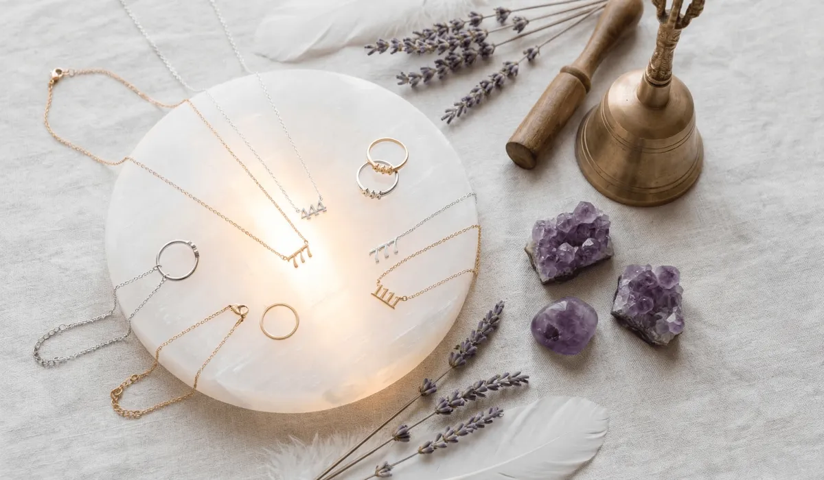 How to Cleanse and Charge Your Angel Number Jewelry for Positive Energy 1 - Buddha Bodhis Angel number jewelry pieces resting on a Selenite charging plate for energetic recharging and amplification.