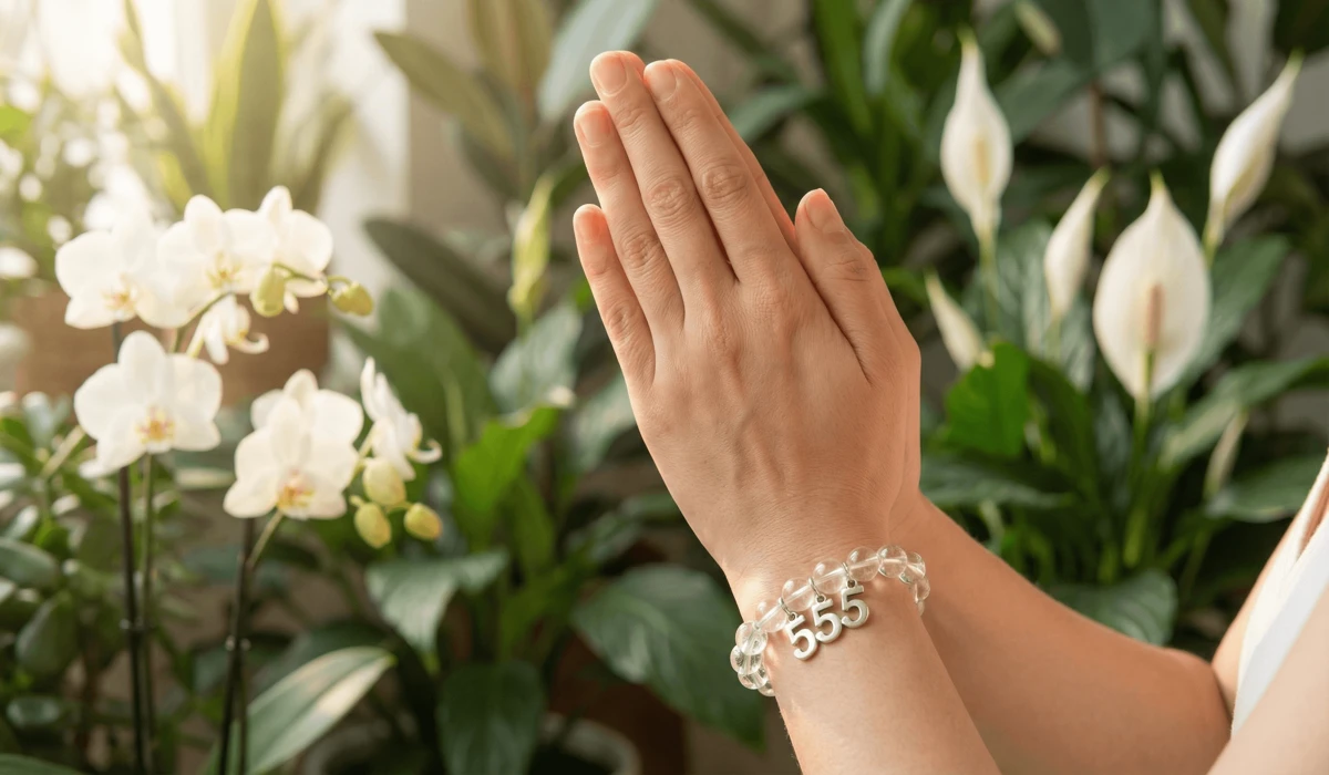 The Meaning of 555 Angel Number Bracelets: Embracing Change and Transformation 3 - Buddha Bodhis A person wearing a 555 bracelet on the left wrist during a manifestation and intention-setting ritual.