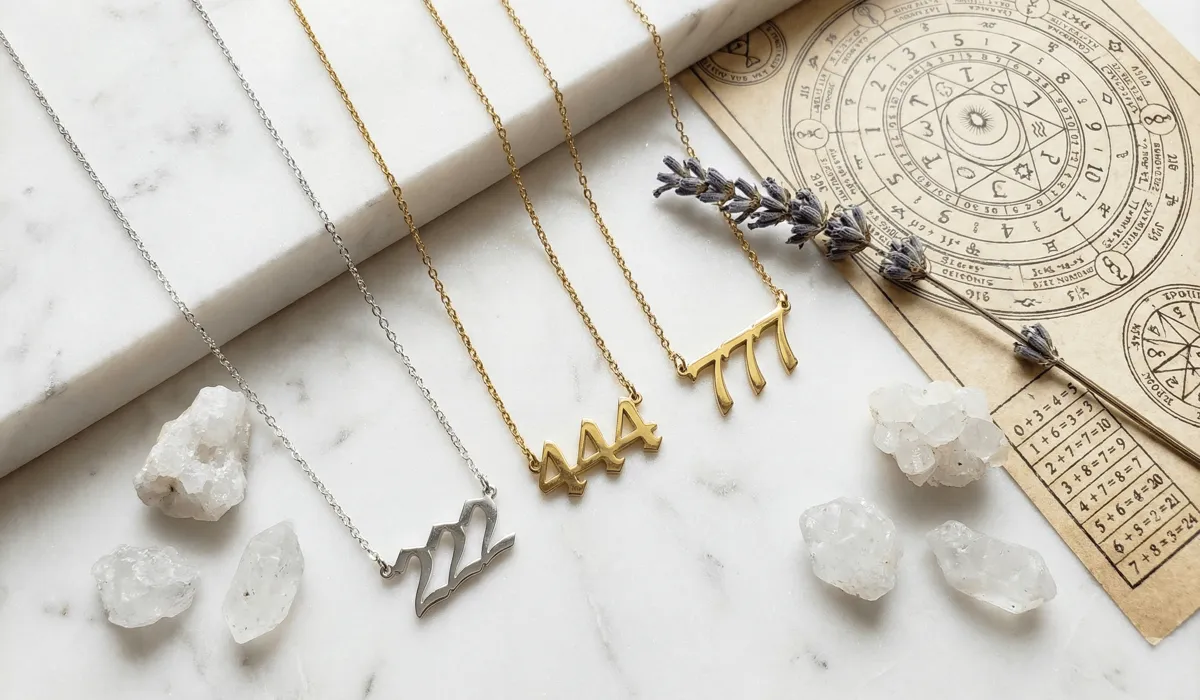 Understanding the Angel Number Jewelry Trend and Its Divine Meaning 1 - Buddha Bodhis Various angel number necklaces in gold and silver arranged with crystals to symbolize spiritual meaning and numerology in fashion.