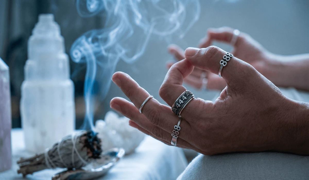 The Minimalist Silver Angel Number Collection: Meaningful Jewelry for Spiritual Growth 1 - Buddha Bodhis Close-up of silver angel number rings 444 and 888 worn during meditation for protection and abundance manifestation.