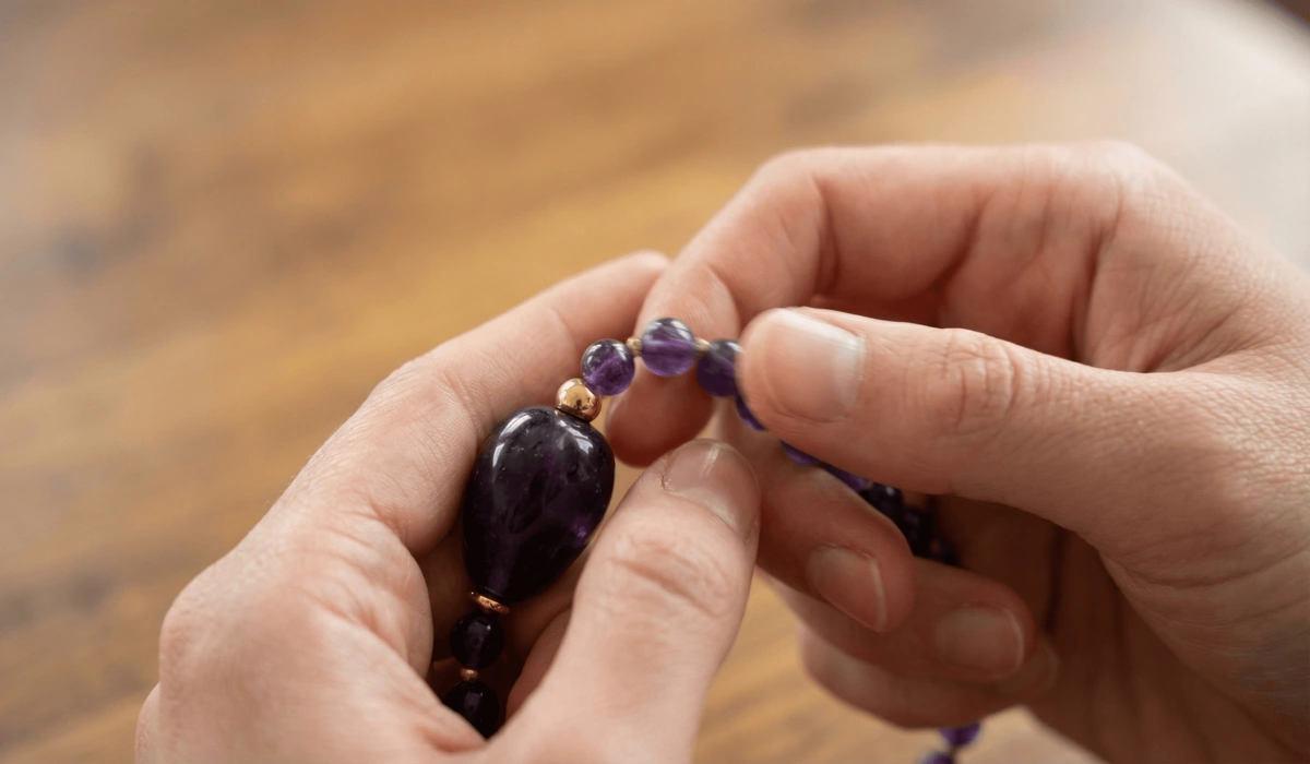 How to Use Tibetan Bracelets to Enhance Meditation and Breathwork 2 - Buddha Bodhis Close-up demonstration of using Tibetan beads to count breaths and recite mantras during a mindfulness session.