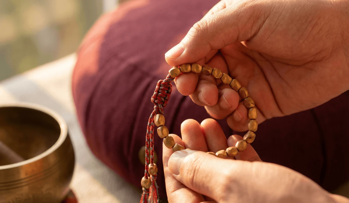 How to Use Tibetan Bracelets to Enhance Meditation and Breathwork - Buddha Bodhis Close-up of a Tibetan sandalwood and copper bracelet with a traditional hand-knotted lucky knot, used as a meditation anchor.