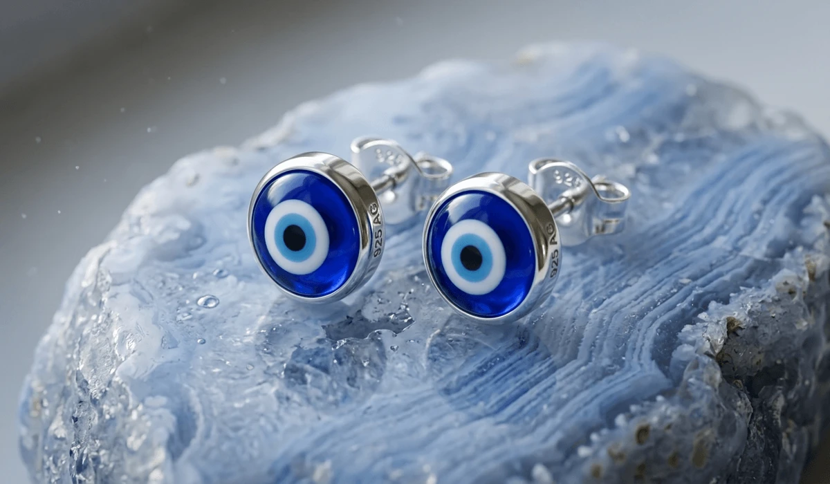 The Guide to Evil Eye Earrings: Meaning and Spiritual Protection - Buddha Bodhis Close-up of 925 sterling silver evil eye stud earrings with traditional blue glass amulets for spiritual protection.
