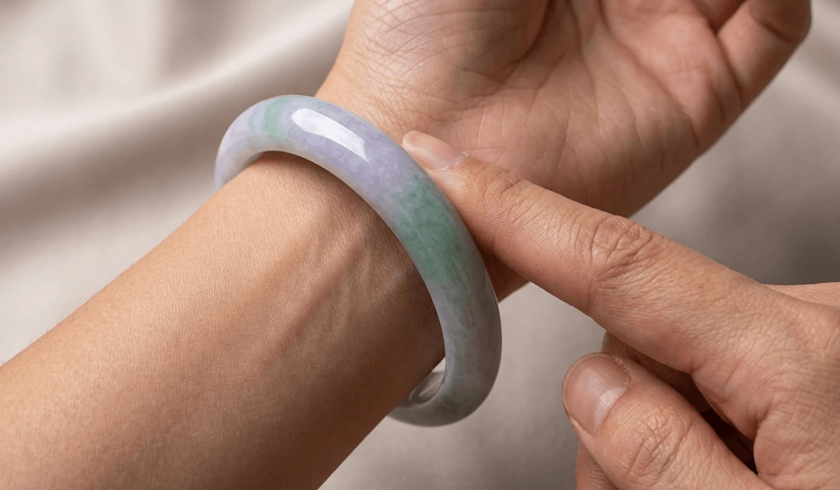 How to Measure Your Hand for the Perfect Jade Bangle Size 4 - Buddha Bodhis Close-up showing the ideal two-finger gap between a jade bangle and the wrist to ensure a comfortable and safe fit.