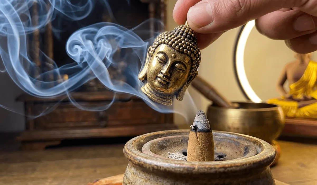 Is It Disrespectful to Wear a Buddha Head Pin? Sacred Symbolism and Jewelry Etiquette - Buddha Bodhis Purifying a golden Buddha head pin with sacred sandalwood incense smoke before wearing