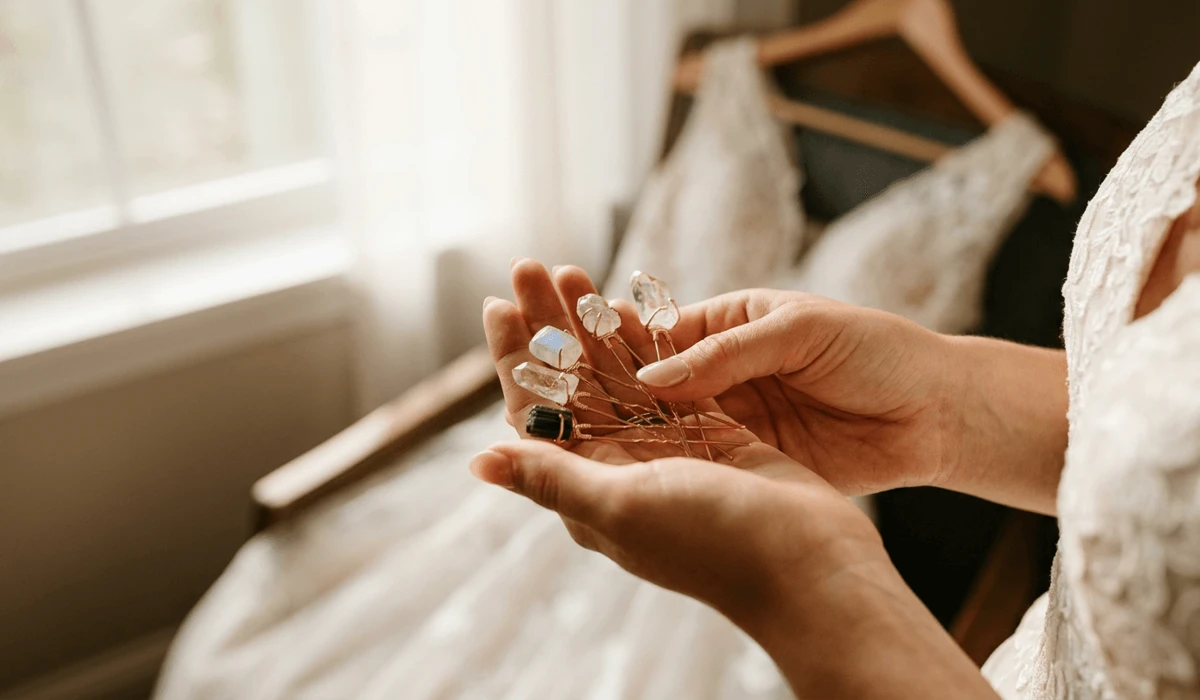 Traditional & Meaningful Bridal Hair Pins for Your Wedding Day 1 - Buddha Bodhis Bride holding spiritual gemstone hairpins during a quiet morning intention-setting wedding ritual.