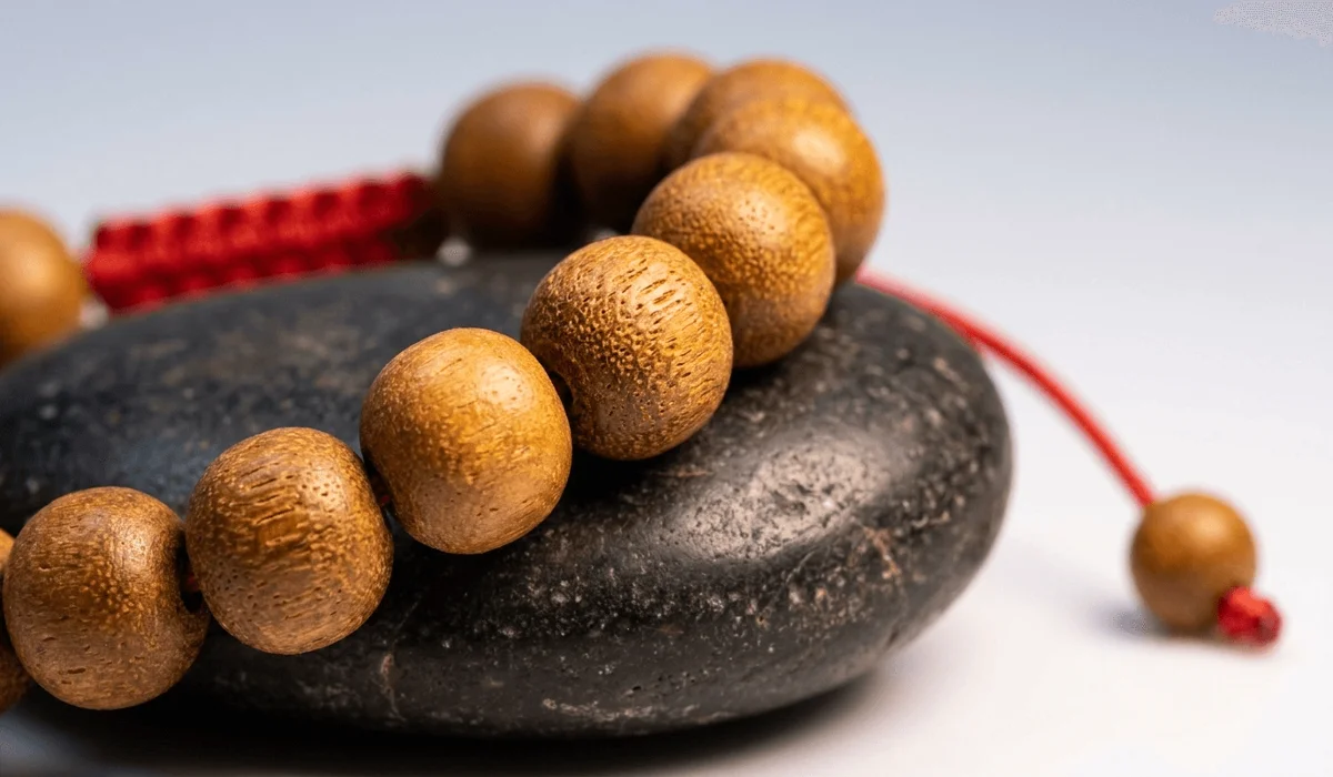 Can You Wear a Sandalwood Bracelet in the Shower? Practical Care Guidelines - Buddha Bodhis Close-up photo of authentic natural sandalwood wrist mala beads showing raw wood grain texture and warm warm brown hue.