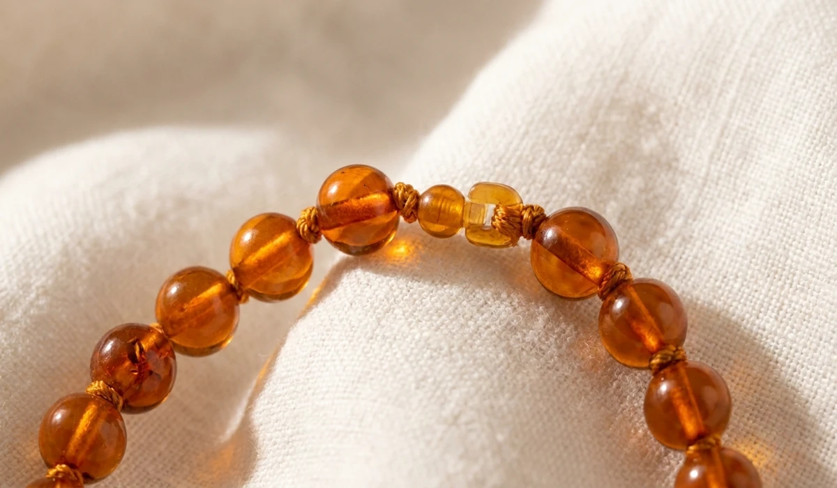 How to Identify Real Baltic Amber: A Guide to Spotting Plastic Imitations 2 - Buddha Bodhis Detailed view of a safety-knotted Baltic amber bracelet for kids with smooth beads and a breakaway clasp.